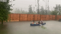 Family Turns Flooded Backyard into Canoe Fun