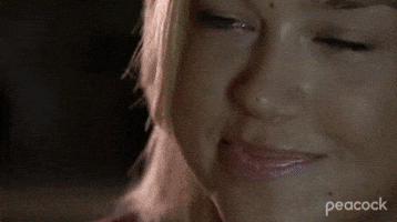 TV gif. Adrianne Palicki as Tyra Collette in Friday Night Lights smirks at someone, and nods her head as if impressed. She holds a red solo cup up and clinks cups with someone as she says, “Amen.”