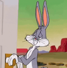 Cartoon gif. Bugs Bunny from Looney Tunes has one hand on a door knob as he stands out in a desert. He looks bored and puts his other hand up to stifle a yawn. 