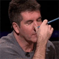 Reality TV gif An irritated Simon Cowell as a judge on American Idol does a facepalm of sorts as he rubs his eyes