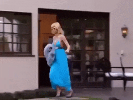 Celebrity gif. Paris Hilton scammers out of her home and teeters over to her car, obviously running late for something. She slams her car door shut and peels out.