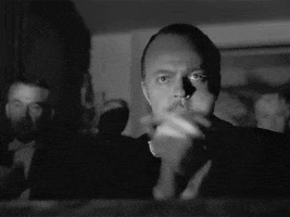 Movie gif. Orson Welles as Charles in Citizen Kane. He is clapping very seriously, putting intention behind each clap and he stares directly ahead, in a very deadly manner. 