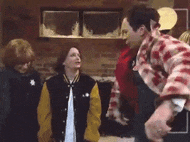 SNL gif. Amy Poehler, Rachel Dratch and Jimmy Fallon in a sketch, are outside in the cold, wearing fall clothes. Jimmy runs to Rachel and they wrap their arms around each other and start making out, as Amy looks on, smiling uncomfortably. Text, "You are."
