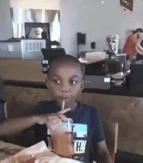 Video gif. We zoom in quickly on a young boy's face as he finishes taking a drink from a straw, turns his head to the side, then looks at us with eyes wide to say, "no," in exasperation.