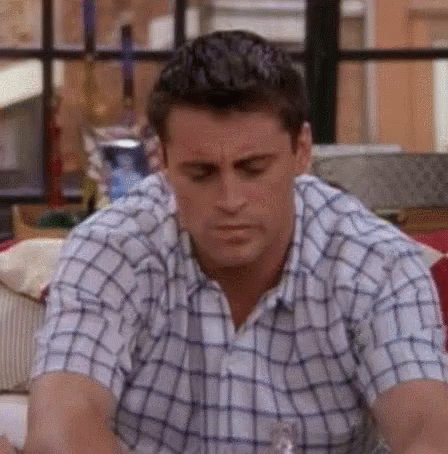 Friends gif. Matt LeBlanc as Joey looks around, lost in a group conversation. He nods and laughs with false enthusiasm, then looks around again, this time bitter and suspicious.