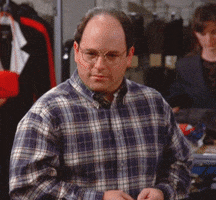 Seinfeld gif. Jason Alexander as George appears concerned, glancing side to side and breathing deeply as his hand covers his mouth and then grazes his chest.