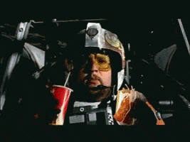 Movie gif. Parody of Star Wars. X-Wing rebel fighters fly over the death star. One of the fighters has his hands full with a soda and a bag of fries in each hand. He loses control of his ship and crashes into the death star.