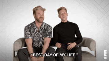 Reality TV gif. Justin Anderson and Austin Rhodes on Very Cavallari sit next to each other for an interview. Austin smiles with his hand on Justin's knee as he smiles and says, "Best day of my life." And Justin who has been looking at Austin the whole time says, "Best day of my life too."