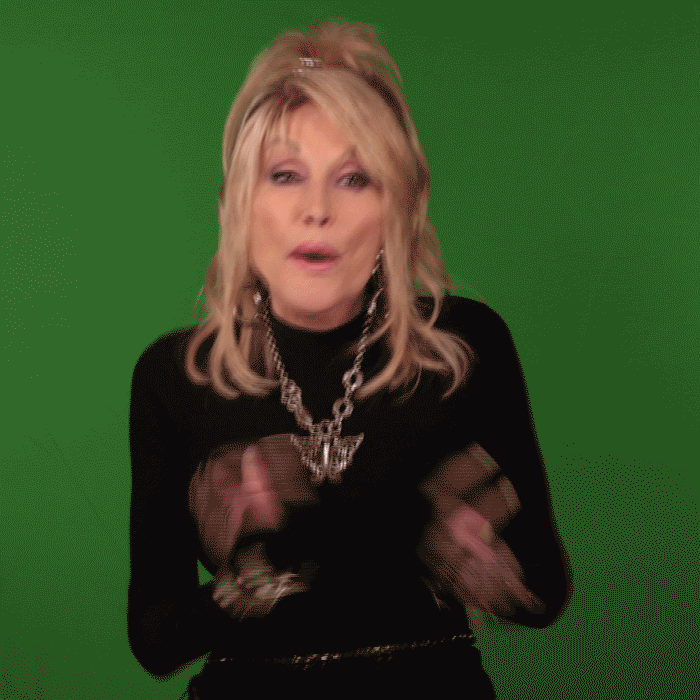 Celebrity gif. Music legend Dolly Parton enthusiastically claps in front of a green screen with an expression of joy on her face. 