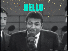 TV gif. Black-and-white footage of the Mills Brothers performing on stage, close-up on the singer and the two men on either side of him. Gold sparkles are overlaid on top and text reads, "Hello, happy holidays."