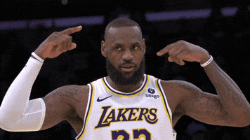 Sports gif. Lebron James walks across the court in slow motion, spinning both of his pointer fingers around his ears like the wheels are turning. 