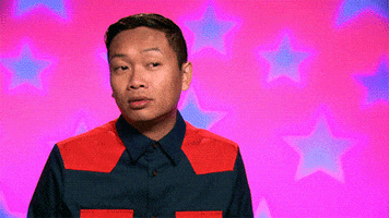 Reality TV gif. Jujubee on RuPaul's Drag Race nods, points to his head and then points forwards. 