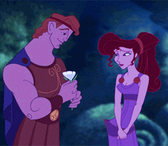 Disney gif. Hercules gives Megara a white flower and kisses her on the cheek.