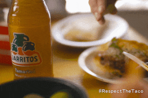 Ad gif. Close up of a yellow Jarritos soda bottle next to a hand squeezing lime on top of tacos. The bottom right text reads, "Hashtag Respect The Taco."