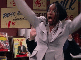 TV gif. Erika Alexander as Maxine in Living Single steps back with her arms up and her mouth gaping open in shock.