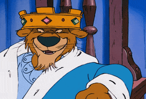 Disney gif. Prince John from the animated Robin Hood movie sits on his throne. He looks over with a smug look on his face and nods while pointing over at someone. 