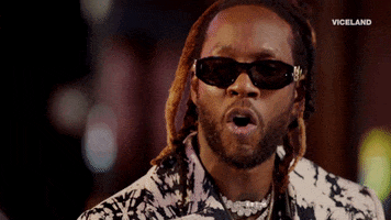 Celebrity gif. Rapper Two Chains raises his head and forms an O with his mouth as if in realization. 