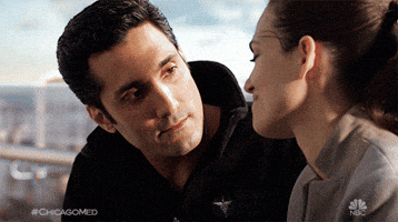 TV gif. Dominic Rains as Crockett puts his arm around Torrey DeVitto as Natalie on Chicago Med, as she leans her head on his shoulder and they rock back and forth.