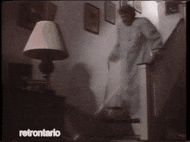 Ad gif. Three consecutive clips of elderly people dramatically falling down. An old woman falls down the stairs. An old man clutches his chest and falls over. An old woman watering plants drops her watering can and begins to fall.