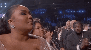 Celebrity gif. Lizzo at the Grammys stands in the audience and nods seriously like she wholeheartedly agrees with something. 