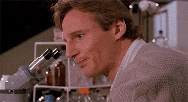 Movie gif. Liam Neeson as Darkman turns away from a microscope and lets out a exhale before repeatedly asking, "Why? Why? Why? Why?" which appears as text.