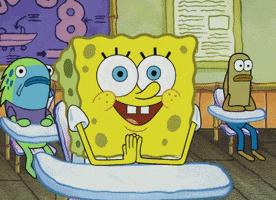 SpongeBob gif. Spongebob sits behind a desk as his wide round eyes blink slowly as if he were waiting patiently. 
