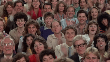 TV gif. From At Home with Amy Sedaris, a crowded audience applauds voraciously, smiling and cheering.