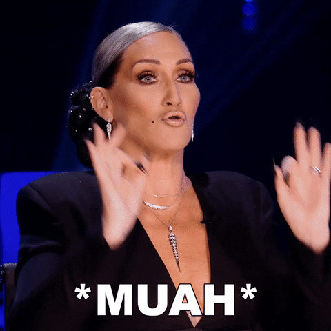 Reality TV gif. Michelle Visage on Queen of the Universe holds her hands up in the okay sign, and says, “*muah* Fantastic” and smiles proudly.