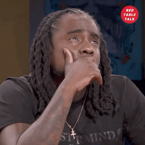 Celebrity gif. Wale is being interviewed on Red Table Talk, and he's musing over a question. He looks up and strokes his mustache thoughtfully before looking back at us.  