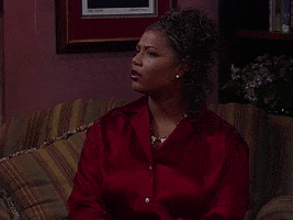TV gif. Queen Latifah as Khadijah from Living Single looks pensive and slightly weirded out as she reacts to something offscreen.