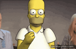 Video gif. Using a filter to look like Homer from the Simpsons, a person looks blankly while throwing confetti.