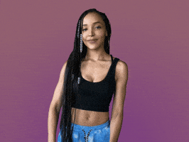 Celebrity gif. Tinashe looks at us with a smirk on her face. She leans back and holds two big thumbs up. Little white lines shootout next to her thumbs to emphasize them. 