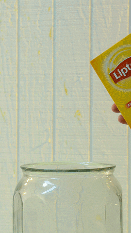 Ad gif. Hand holds a box of Lipton Tea bags and then crushed it. A stream of tea pours out of the box and into a big glass jar with ice.
