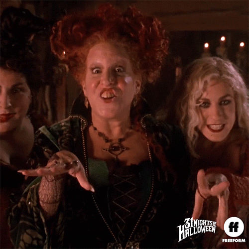 Movie gif. The Sanderson Sisters from Hocus Pocus stand close to each other, their hands waving around like they’re casting a spell. They have evil expressions on their faces as if they're excited to spook someone with their magic.