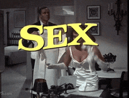 Movie gif. In a white satin dress, Natalie Wood as Helen slams down the telephone and grabs her white coat from the man holding it out for her and hurries out the door. Title text pops onto the screen, "Warner Bros Presents: Sex and the Single Girl."