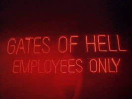 Movie gif. A red neon sign that says, “Gates of Hell Employees Only,” hangs in front of an obscured person. Fog rolls in and the red neon light floods the area in this scene from Wacko. 