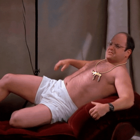 Seinfeld gif. Jason Alexander as George Constanza in Seinfeld, in his underwear, leans back seductively on a chaise, wearing a chain with the Hebrew character for "l'chaim," big golden letters appear above reading, "Birthday boy."