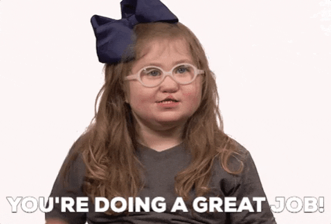 Video gif. A little girl wearing a large blue bow and white-rimmed glasses gives us a giggling thumbs up. Text, "You're doing a great job!"