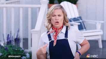 Celebrity gif. Amy Poehler, in overalls and a bandana, shakes her head, waving her hand in an emphatic "cut that" gesture, narrowing her lips into a "Noooooo."