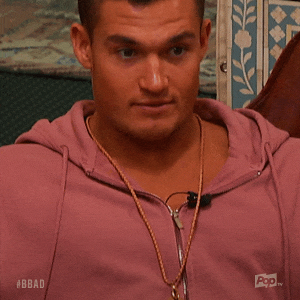 Reality TV gif. Jackson Michie on Big Brother: After Dark smiles, nods, and holds out to say, "I know you know."
