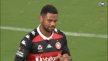 Sports gif. Kwame Yeboah jogs down a field and claps his hands, then high fives Bernie Ibini and hugs him as they both continue jogging.