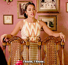 TV gif. A distraught Gina Rodriguez as Jane in Jane the Virgin drops her head in shame, leaning over a chair and says, “I know, I know…”