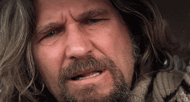 Movie gif. Jeff Bridges as The Dude in The Big Lebowski blinks repeatedly and tilts his head with confusion.