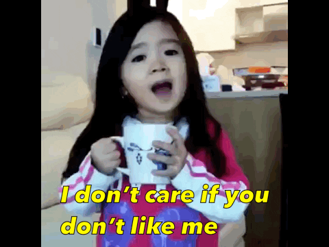 An animated gif video of a little girl holding a mug, saying, "I don't care if you like me, I love me."