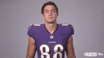 Sports gif. Charlie Kolar from the Baltimore Ravens gives us the first down hand sign while standing in his uniform.