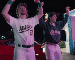 Celebrity gif. Andy Samberg and Mark McGwire
are both wearing Oakland Athletics gear and have their hands up in the air. They sway their hips side to side and whoop and laugh together.