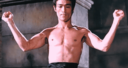 Flexing Bruce Lee GIF