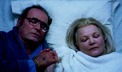 Movie gif. Scene from The Notebook where Duke, played by James Garner, holds onto the hand of Allie, played by Gena Rowlands, as they both lie in a hospital bed.