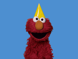 Muppets gif. Elmo wears a yellow pointed party head, throwing his head back and shaking his bum as he dances.