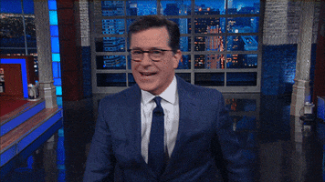 TV gif. On The Late Show, Stephen Colbert smiles and waves to us enthusiastically and says, “Hi!”